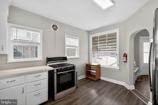 a kitchen with granite countertop a stove and a refrigerator