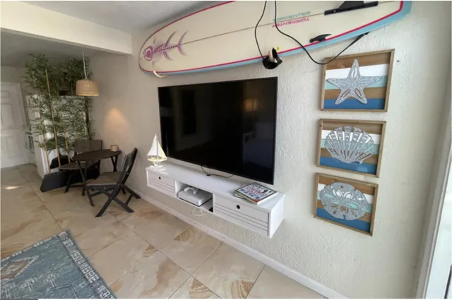 a living room with furniture and a flat screen tv