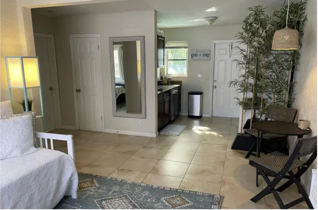 a room with a mirror and furniture