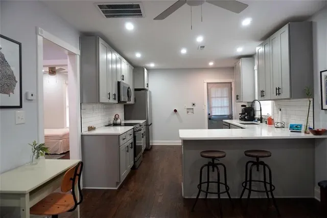 a kitchen with a sink stainless steel appliances and cabinets