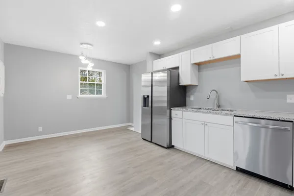 a kitchen with refrigerator and window