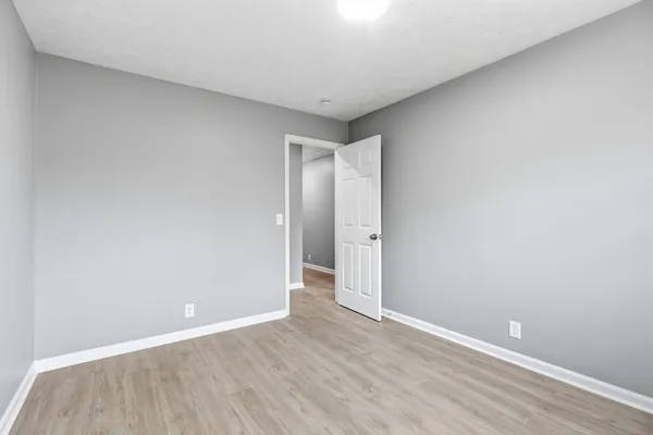 a view of an empty room and wooden floor