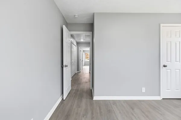 a view of a hallway with wooden floor