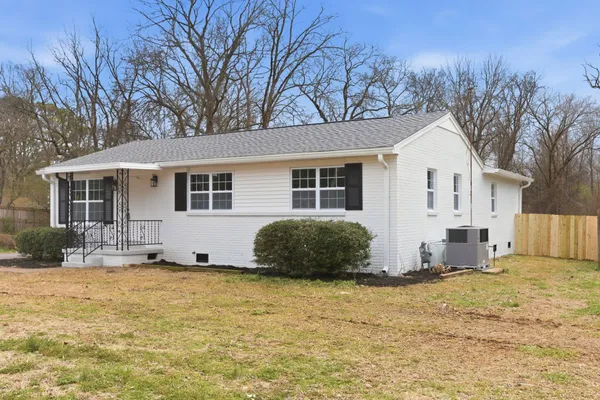 a house that has a tree in front of it