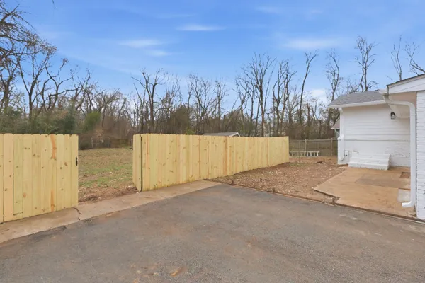 a view of a backyard of the house