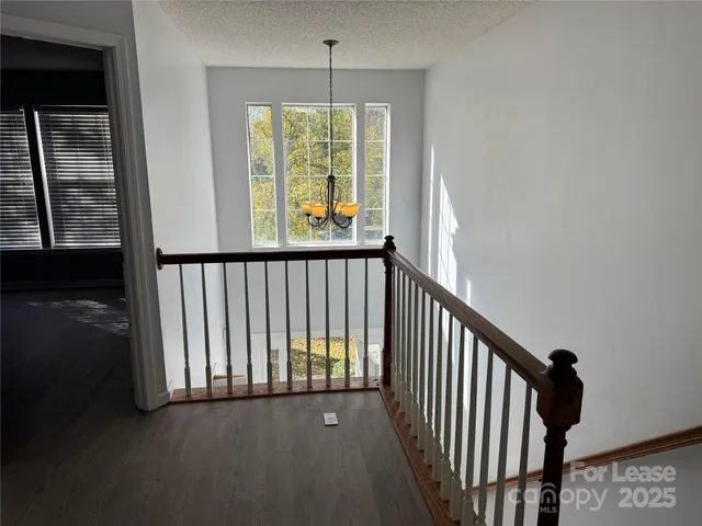 a view of a room with wooden floor and a window