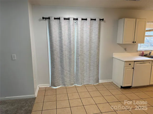 a view of a kitchen with white cabinets