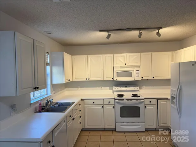 a kitchen with a sink stove and refrigerator