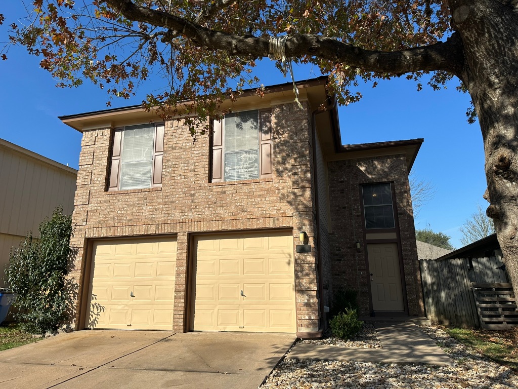 814 Smoke Signal Pass Pflugerville, TX 78660 - Photo 1 of 29 View of front of home with brick siding, driveway, and a garage