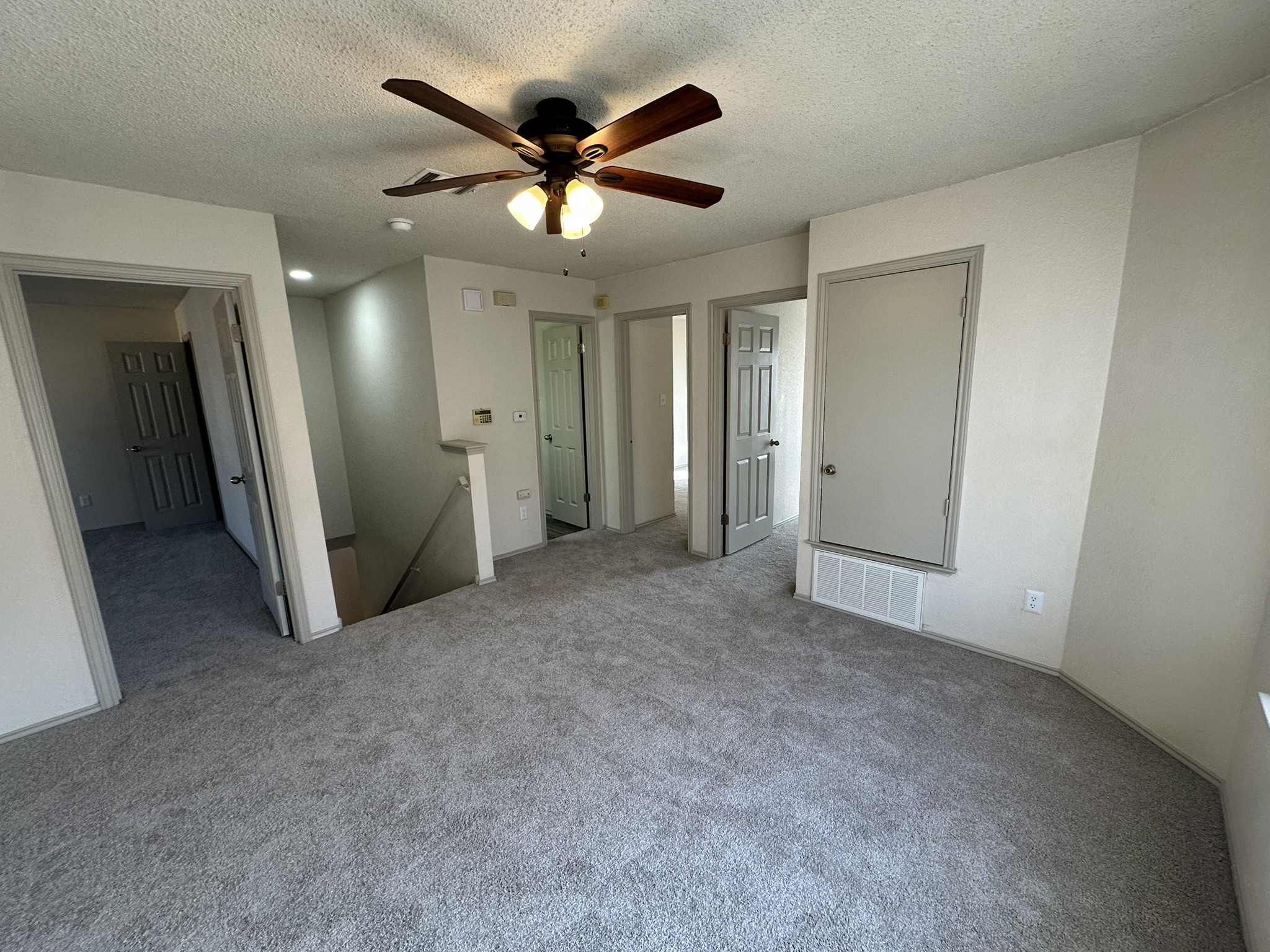 814 Smoke Signal Pass Pflugerville, TX 78660 - Photo 23 of 29 Unfurnished bedroom featuring carpet floors, a textured ceiling, and ceiling fan