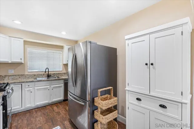 a kitchen with a refrigerator and cabinets