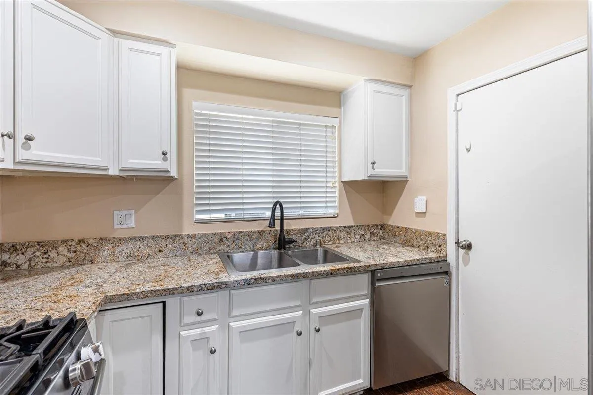 6295 Calle Pavana San Diego, CA 92139 - Photo 12 of 27 a kitchen with granite countertop a sink and a white cabinets