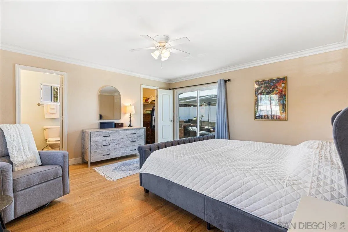 6295 Calle Pavana San Diego, CA 92139 - Photo 13 of 27 a bedroom with a large bed and a couch