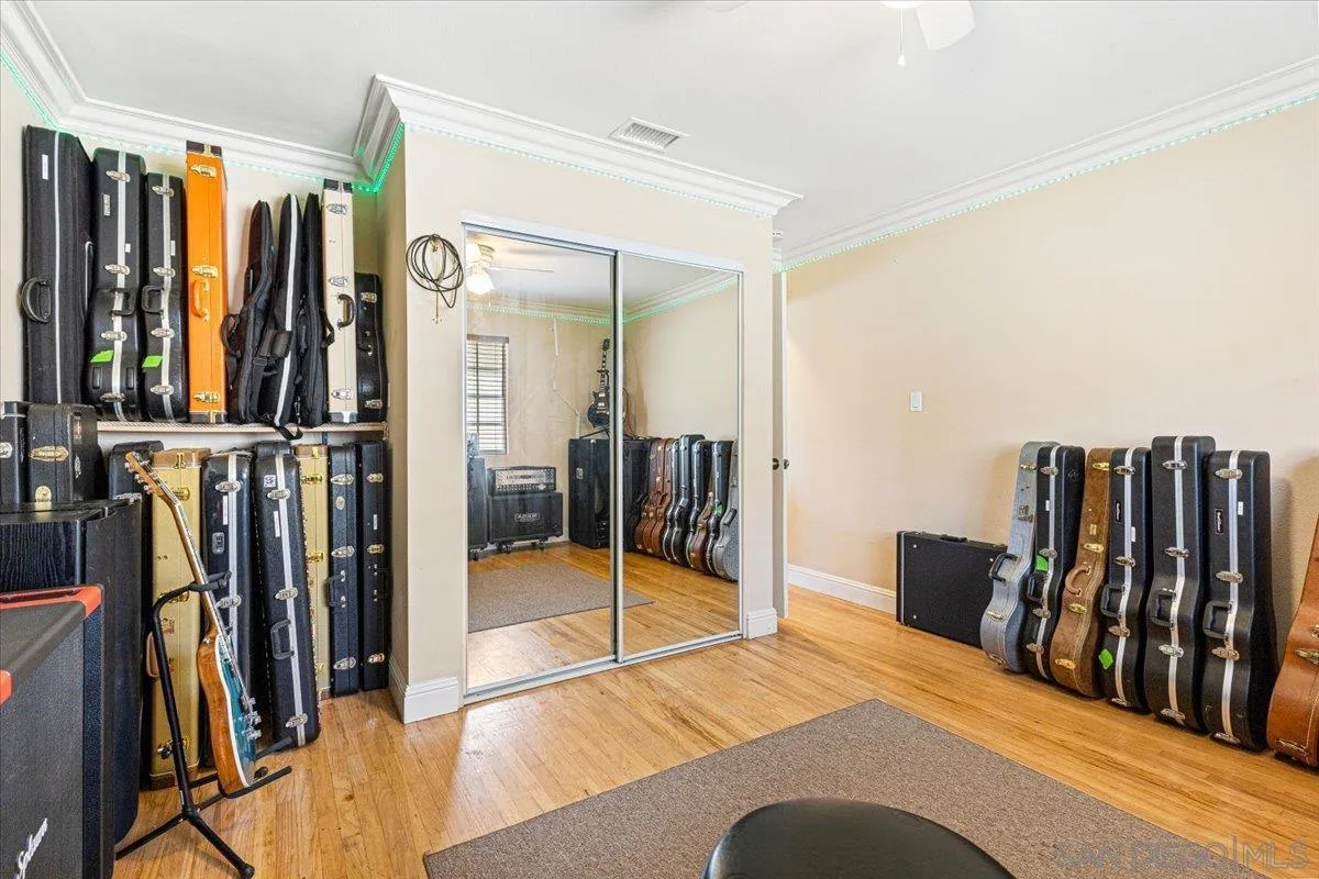 6295 Calle Pavana San Diego, CA 92139 - Photo 22 of 27 a bedroom with a bed and wooden floor