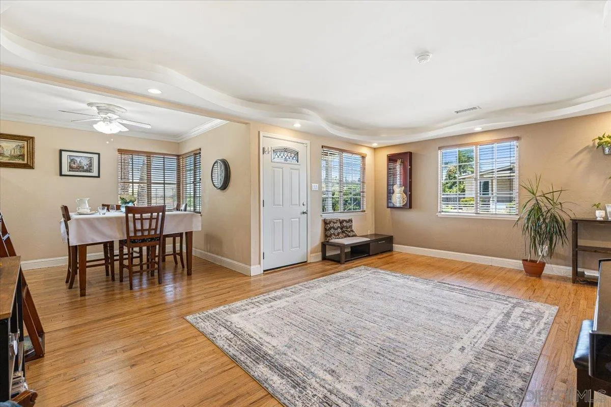6295 Calle Pavana San Diego, CA 92139 - Photo 6 of 27 a livingroom with furniture window and wooden floor