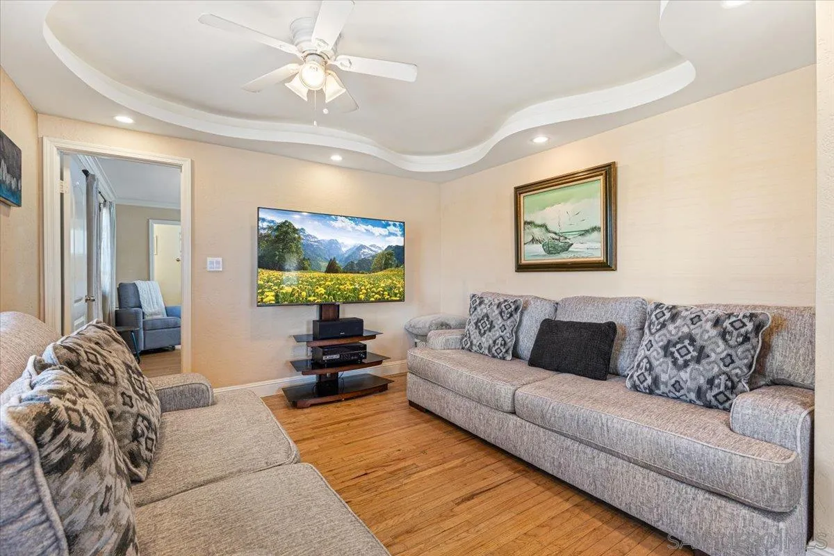 6295 Calle Pavana San Diego, CA 92139 - Photo 7 of 27 a living room with furniture and a flat screen tv