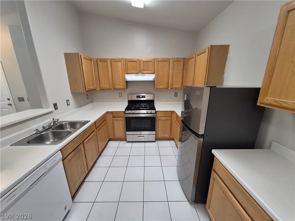 2053 Quarry Ridge Street, Unit 201 Las Vegas, NV 89117 - Photo 17 of 21 A well-lit kitchen with ample cabinet space and modern stainless steel appliances.
