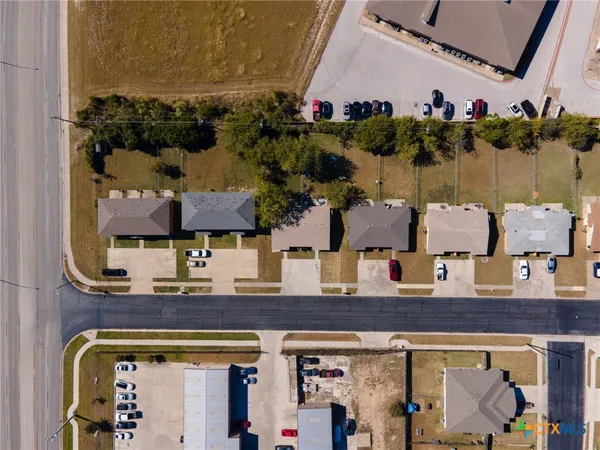 an aerial view of residential houses with outdoor space