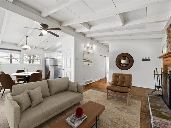 a living room with furniture and a wooden floor
