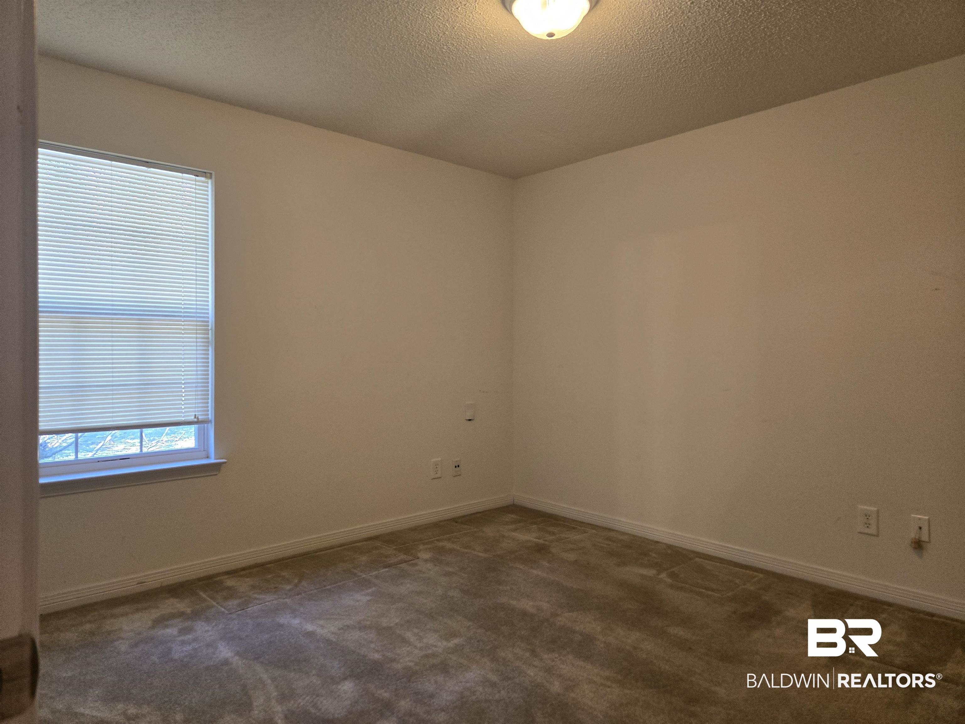 2554 Riverside Drive Mobile, AL 36605 - Photo 23 of 43 Unfurnished room with a textured ceiling and dark colored carpet