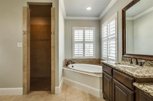 a spacious bathroom with a granite countertop tub sink and mirror
