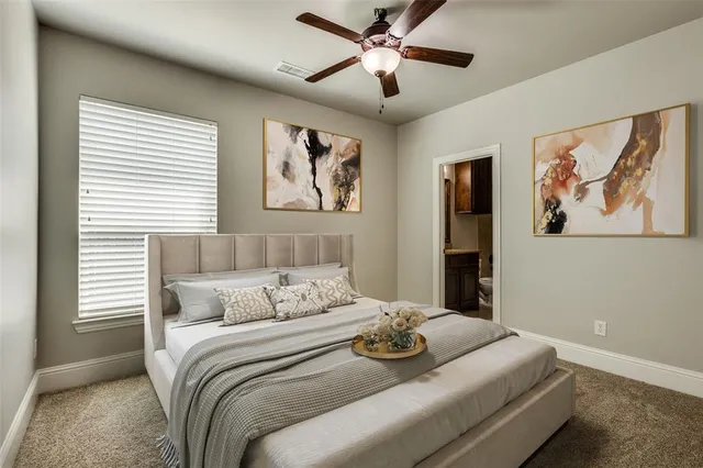 a bedroom with a bed and a painting on the wall