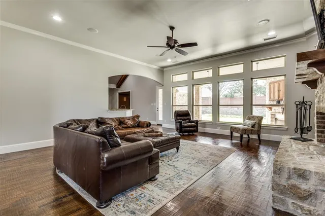 a living room with furniture large window and a table