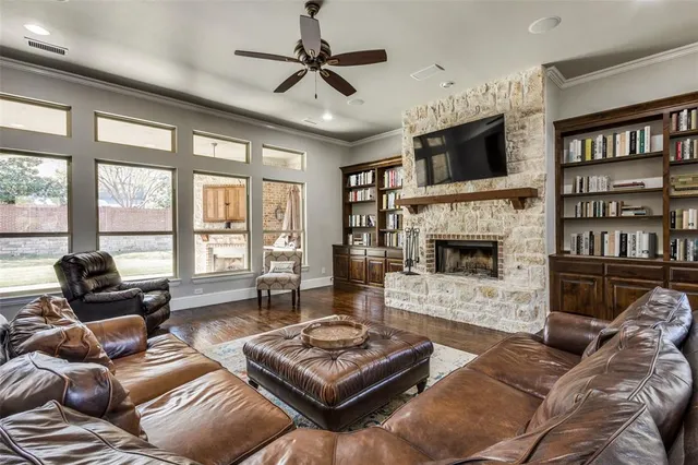 a living room with furniture fireplace and flat screen tv
