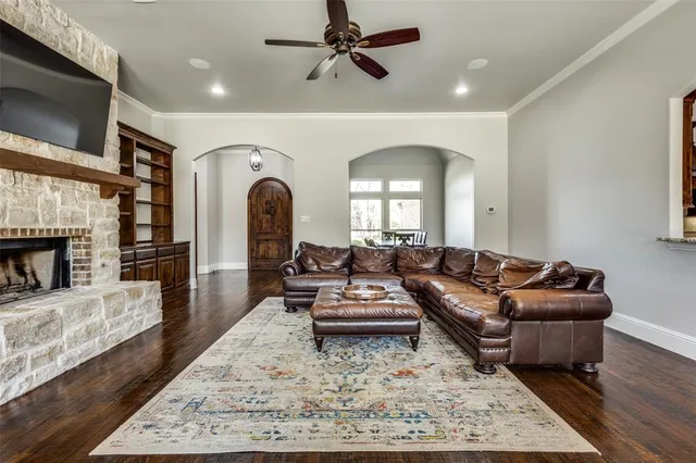 a living room with furniture hard wood floor and a fireplace