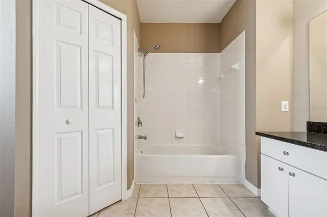 a bathroom with a double vanity sink a mirror and a bathtub