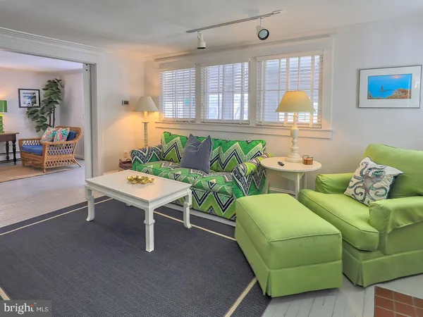 a bedroom with a bed a couch and a flat screen tv