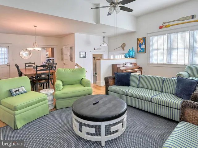 a living room with furniture a couch and a large window
