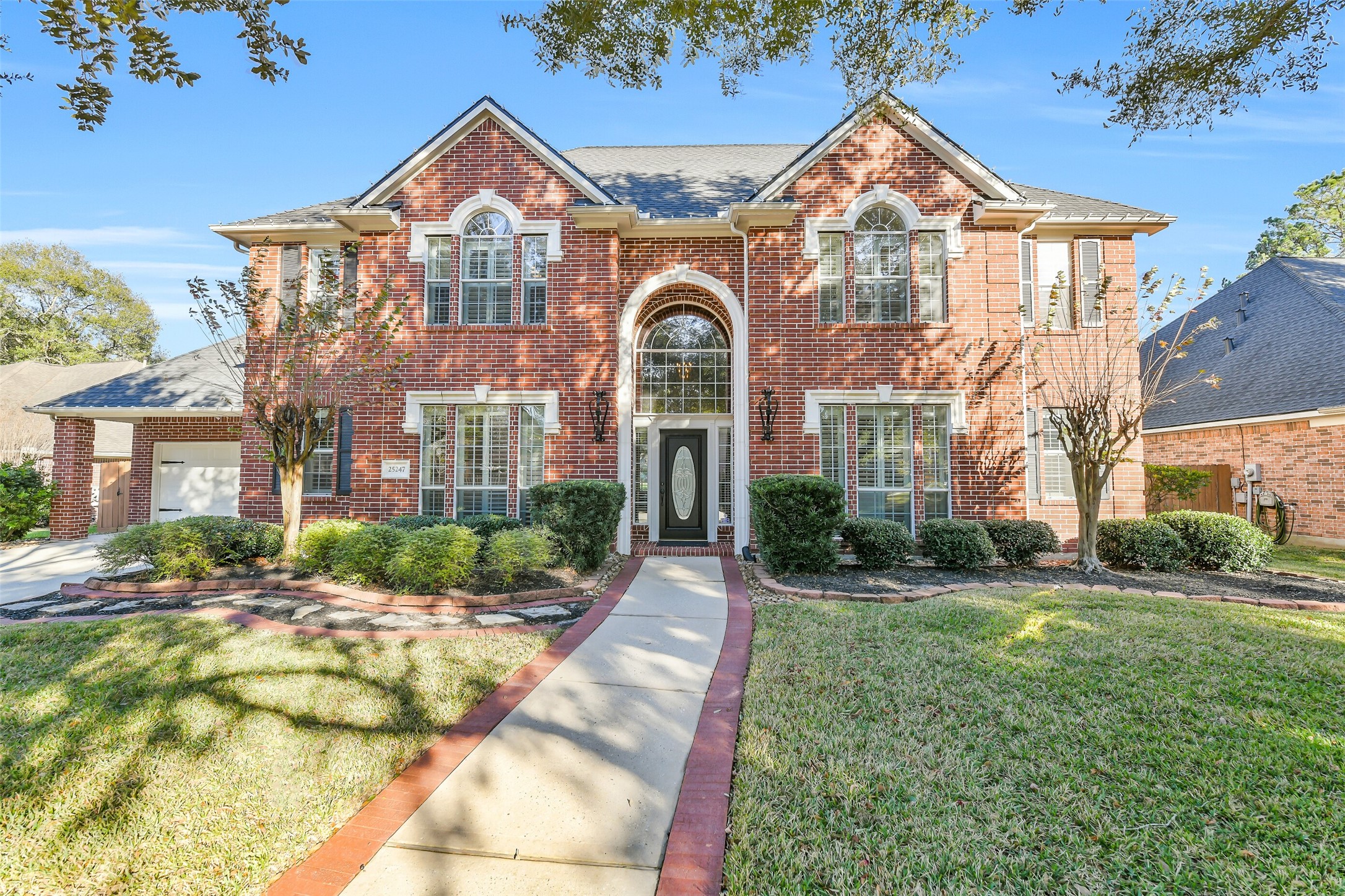25247 Bull Ridge Drive Porter, TX 77365 - Photo 1 of 50 Beautiful curb appeal on this street known for luxury homes on the golf course. Exterior updates include New Roof 2021 and Exterior Paint 2023