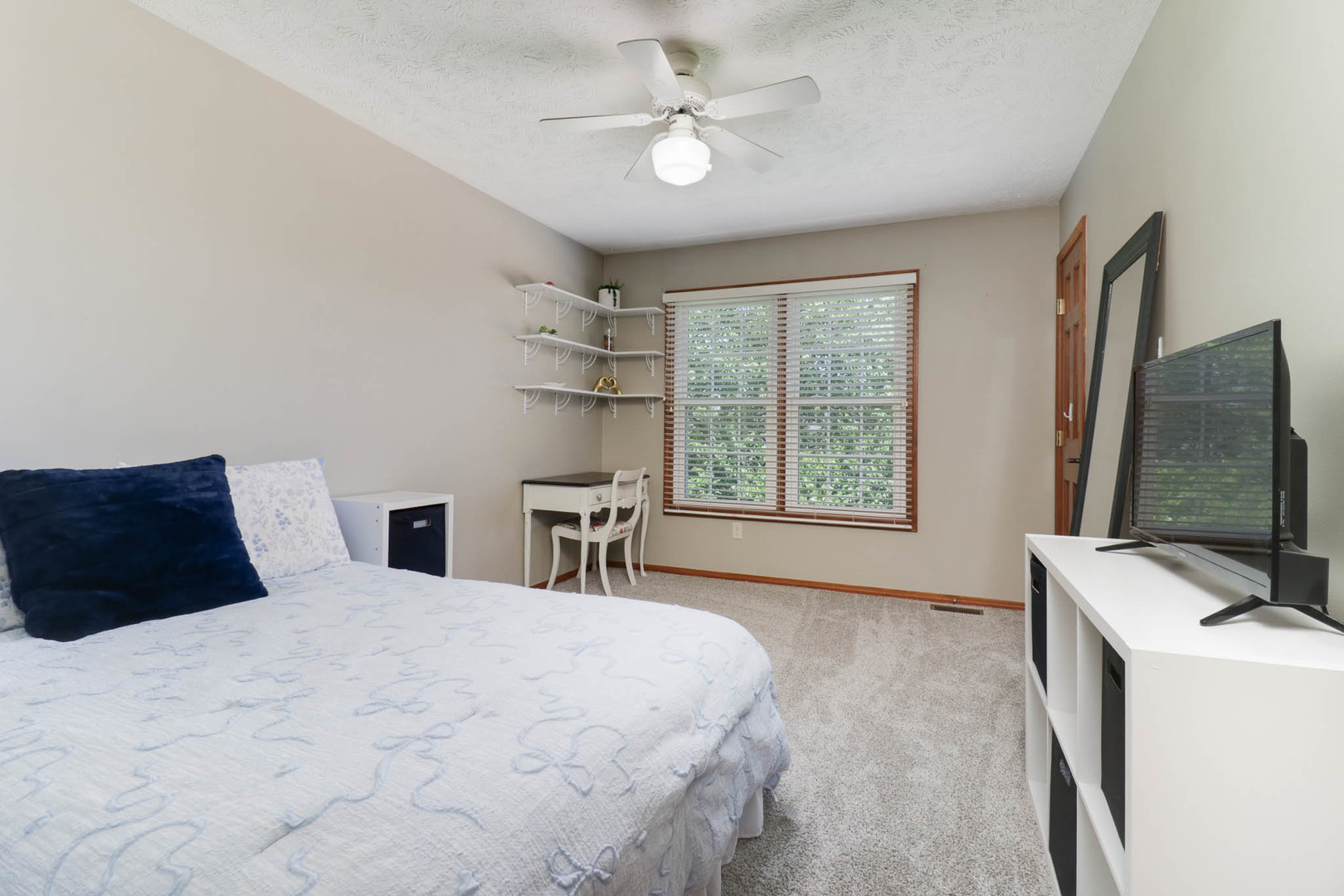 3203 Eagle Crest Road Bloomington, IL 61704 - Photo 25 of 52 a bedroom with a large bed and a flat tv screen on dresser