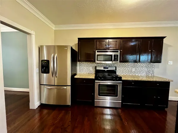 a metallic refrigerator freezer sitting in a kitchen