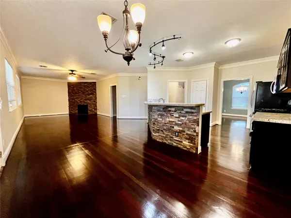 a view of a kitchen with cabinets and wooden floor