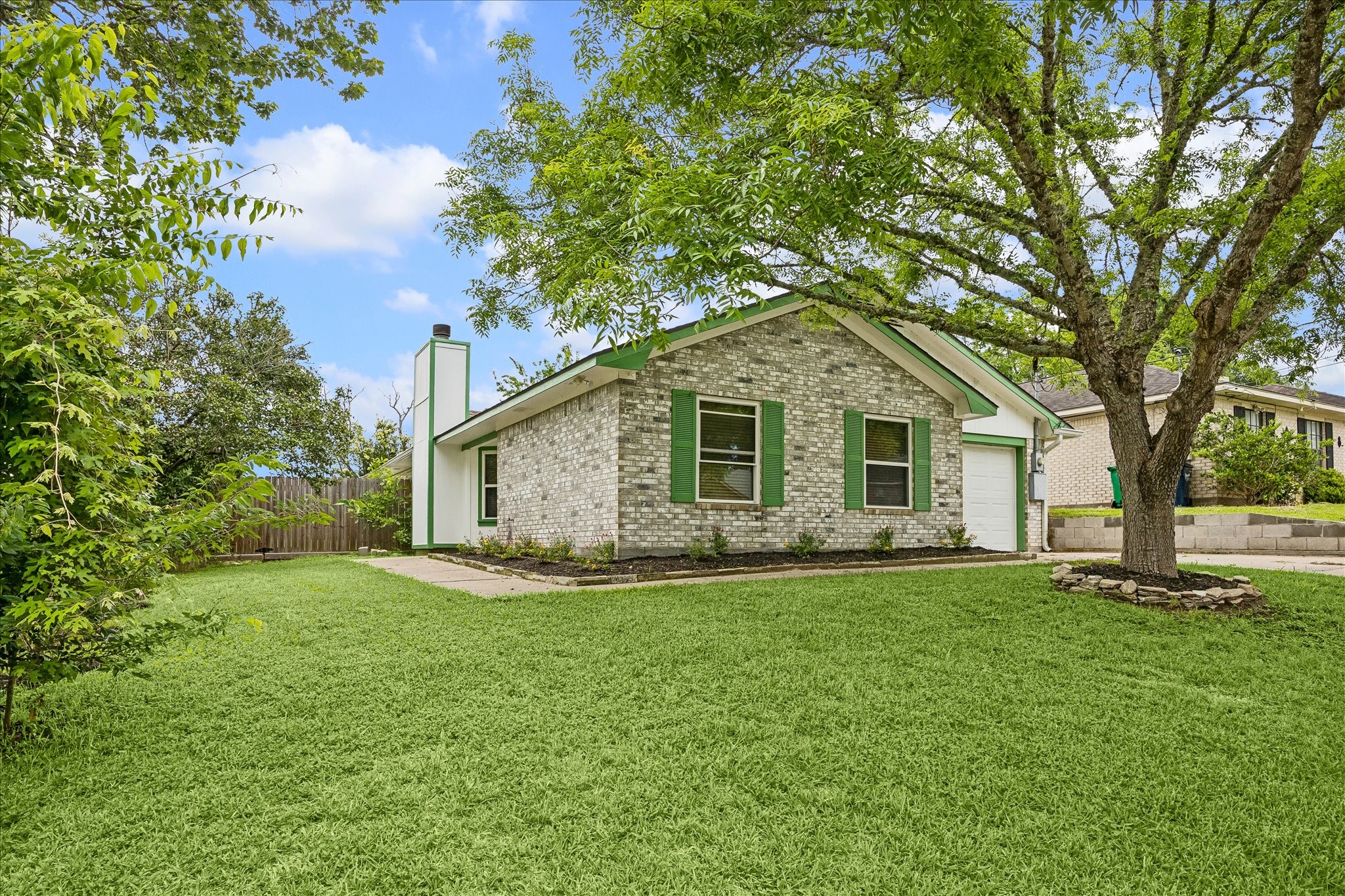 206 Lockett Street Brenham, TX 77833 - Photo 1 of 12 a front view of a house with a yard and trees