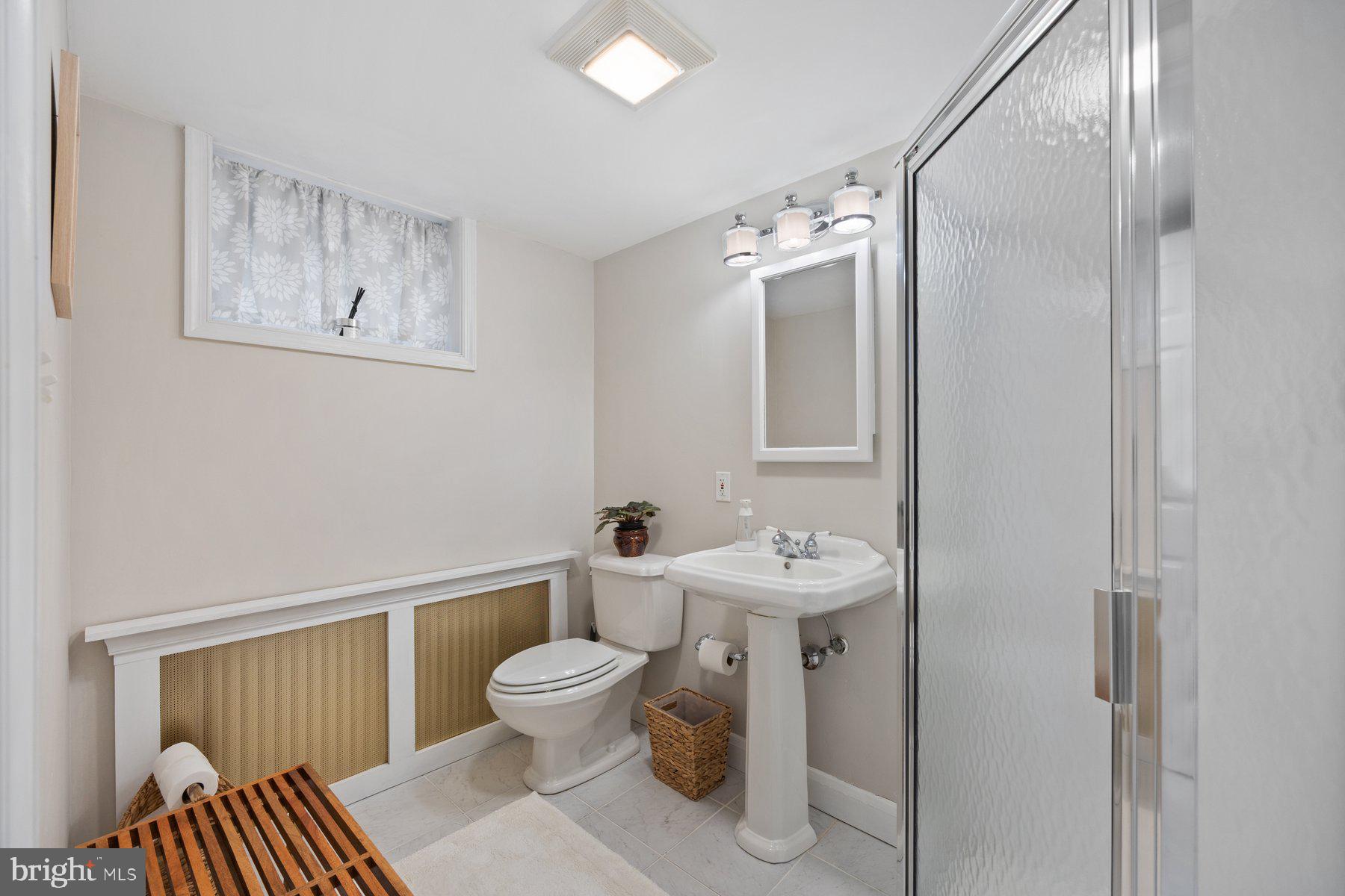 5317 Springlake Way Baltimore, MD 21212 - Photo 29 of 47 a bathroom with a toilet sink and mirror