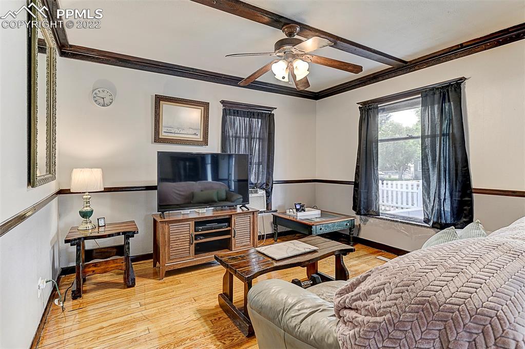 312 10th Street Fowler, CO 81039 - Photo 12 of 35 a bedroom with furniture and a chandelier