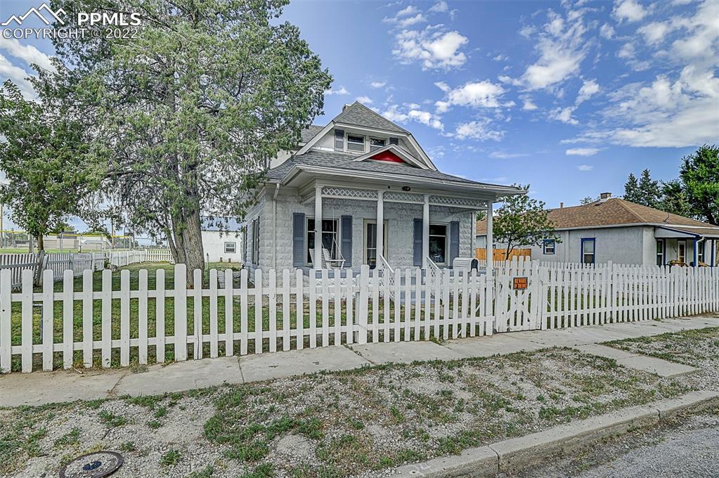 312 10th Street Fowler, CO 81039 - Photo 2 of 35 a view of a house with a small yard and wooden fence
