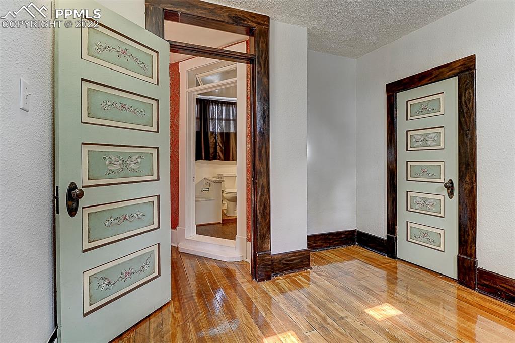 312 10th Street Fowler, CO 81039 - Photo 28 of 35 view of hall way with wooden floor and cabinet