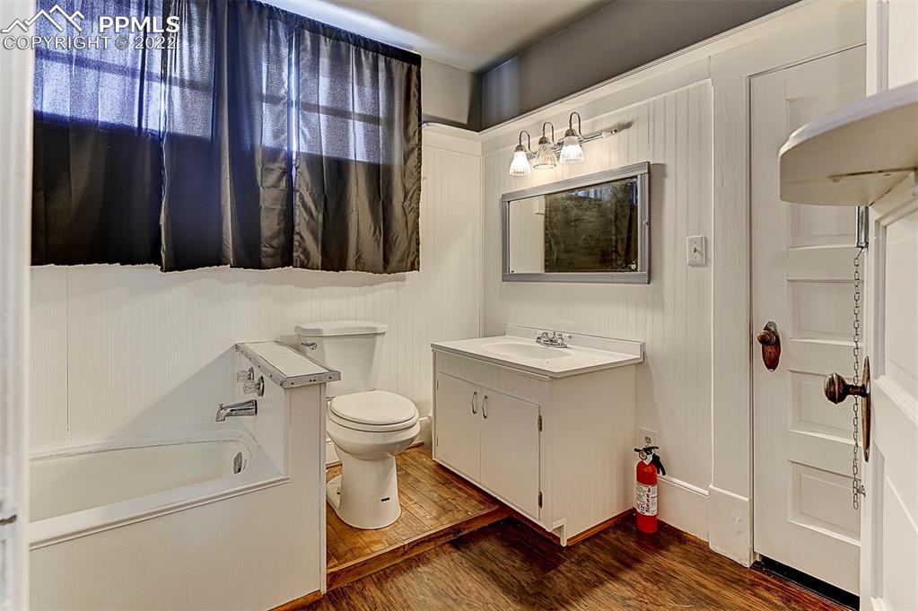 312 10th Street Fowler, CO 81039 - Photo 30 of 35 a bathroom with a sink toilet a mirror and shower