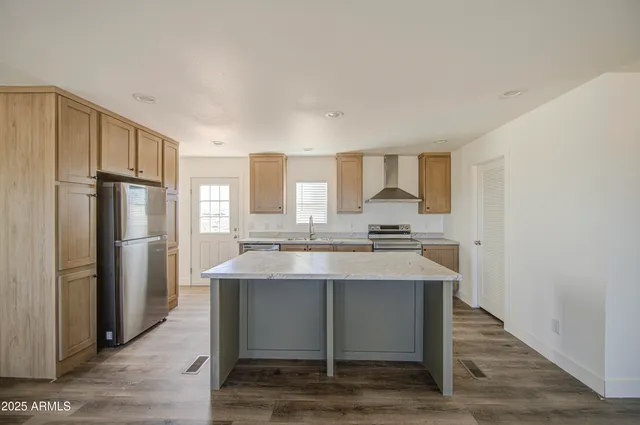 a kitchen with a stove a sink and a refrigerator