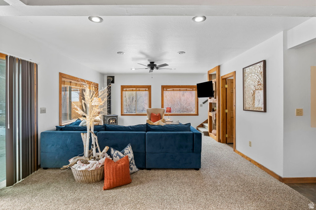 2189 Samak Park Loop, Unit 43 Kamas, UT 84036 - Photo 10 of 48 Living room featuring a wood stove, carpet, ceiling fan, and recessed lighting