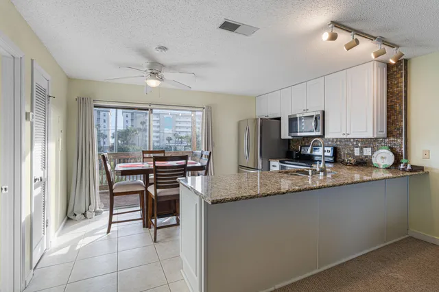 a living room with a couch and chandelier
