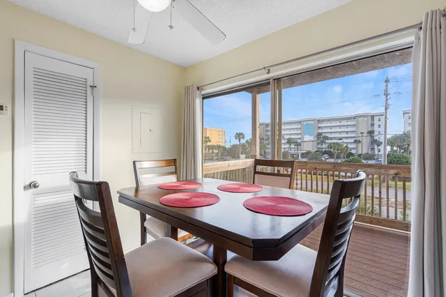 a kitchen with kitchen island granite countertop a table chairs sink and microwave