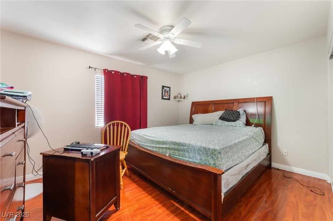 4656 East Desert Inn Road Las Vegas, NV 89121 - Photo 45 of 98 4650 E DI Bedroom with wood finished floors and ceiling fan