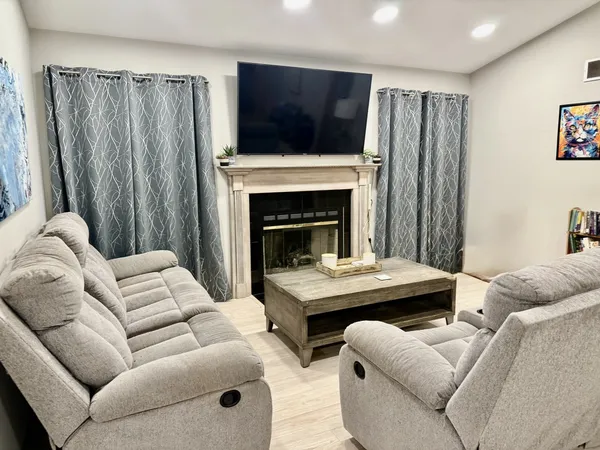 a living room with furniture and a fireplace