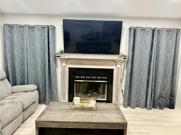 a living room with furniture and a fireplace