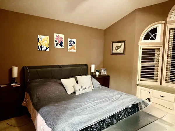 a bedroom with a bed and a window